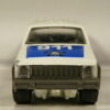 TODOTERRENO 4X4 POLICIA DE SEGUNDA MANO CON ALGUNA SEÑAL DE USO A ESCALA APROXIMADA 1/64. VISTA FRONTAL.